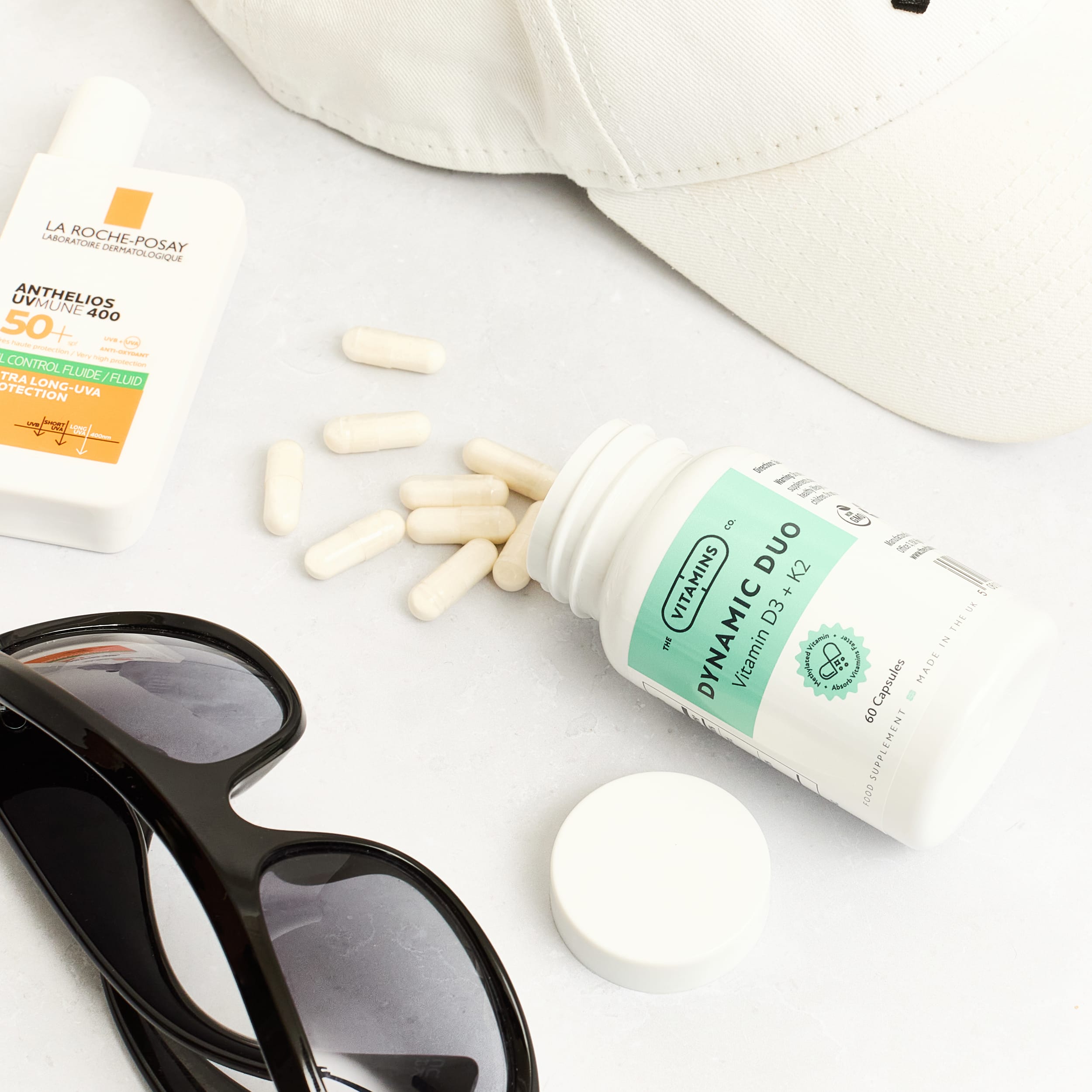 Dynamic Duo Vitamin D3 and K2 capsules by The Vitamins Co beside white plastic bottle