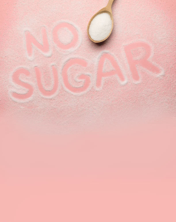 No Sugar written in spilled sugar on a pink surface